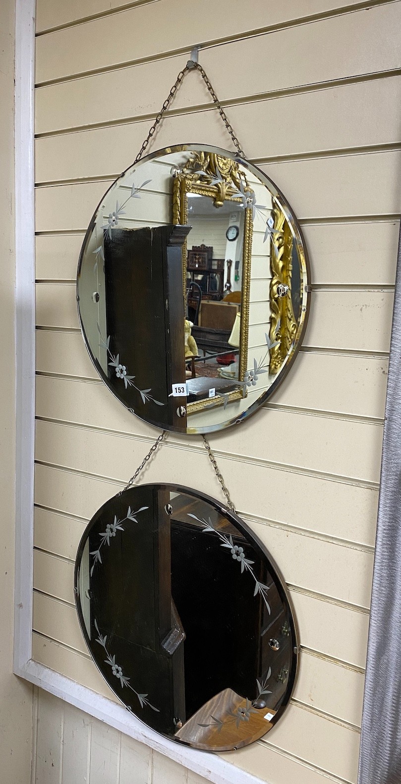 A pair of 1950's circular bevelled wall mirrors, diameter 50cm